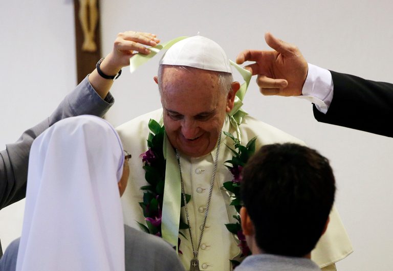 Pope Francis is welcomed by the faithful as he arrives at the the 