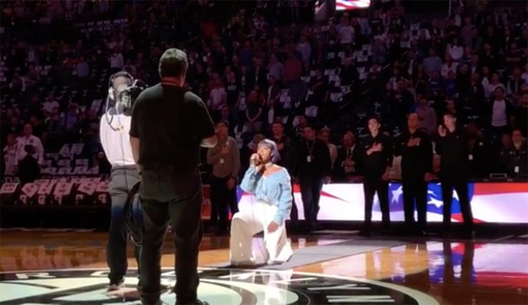 Singer Justine Skye took a knee after performing the national anthem at Friday night's Brooklyn Nets game. (Image courtesy screenshot)