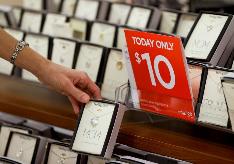   In this Friday, Nov. 23, 2012 photo, a woman browses through a display of jewelry on sale at a J.C. Penney store in Las Vegas. In the midst of the busy holiday shopping season, when retailers can make up to 40 percent of their sales, promotions are actually down 5 percent year over year so far, according to BMO Capital market's sales rack index. (AP Photo/Julie Jacobson)  