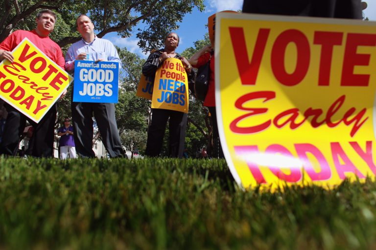 People listen during a get out the vote rally put on by local unions and Democratic politicians on the grounds of the Jackson Memorial hospital on October 18, 2010 in Miami, Florida. (Photo by Joe Raedle/Getty Images)