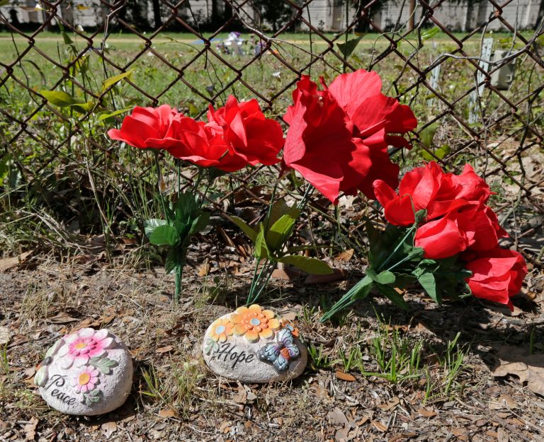 Flowers and stones are placed near the scene where Walter Scott was killed by a North Charleston, S.C., police officer Saturday. (AP Photo)Â 