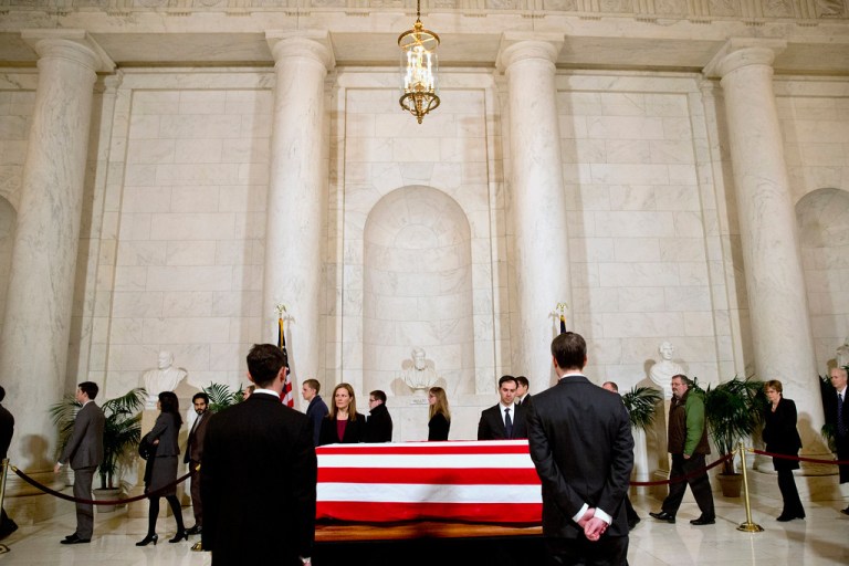 Supreme Court staff attend a private visitation in the Great Hall of the Supreme Court in Washington, Friday, Feb. 19, 2016, where late Supreme Court Justice Antonin Scalia lies in repose. (AP Photo/Jacquelyn Martin, Pool)