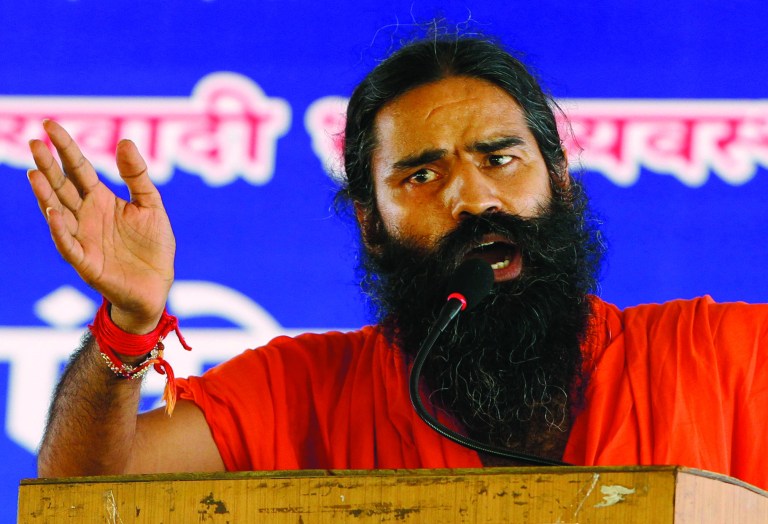 Indian yoga guru Baba Ramdev gestures as he speaks to his supporters at an anti-corruption protest in New Delhi, India, Sunday, Aug. 12, 2012. Ramdev fasted for a fourth day Sunday and threatened to expand his protest nationwide if the government doesn't act decisively to bring back billions of dollars of ill-gotten money that some Indians have allegedly stashed abroad. (AP Photo/Rajesh Kumar Singh)