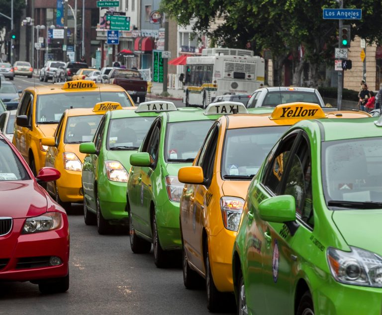 Los Angeles area taxi drivers circle City Hall in their cabs to protest unregulated ride-share services being promoted through smart-phone applications and social media in Los Angeles Tuesday, June 25, 2013. (AP Photo/Damian Dovarganes)