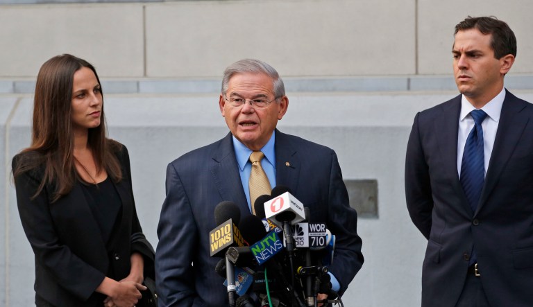Sen. Bob Menendez, center, talks to reporters while his children look on outside the courthouse in New Jersey. The corruption trial will examine whether Menendez was illegally lobbying for Salomon Melgen, who gave him political contributions and gifts including luxury vacations. (AP Photo/Seth Wenig)