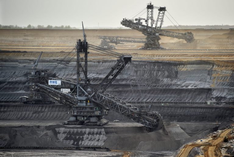 In this picture taken Thursday, April 3, 2014, giant machines dig for brown coal at the open-cast mining Garzweiler near the city of Grevenbroich, western Germany. After concluding that global warming is almost certainly man-made and poses a grave threat to humanity, the U.N.-sponsored expert panel on climate change is moving on to the next phase: what to do about it. The Intergovernmental Panel on Climate Change, or IPCC, startet a meeting in Berlin Monday, April 7, 2014,to chart ways for the world to rein in the greenhouse gas emissions that scientists say are overheating the planet. (AP Photo/Martin Meissner)