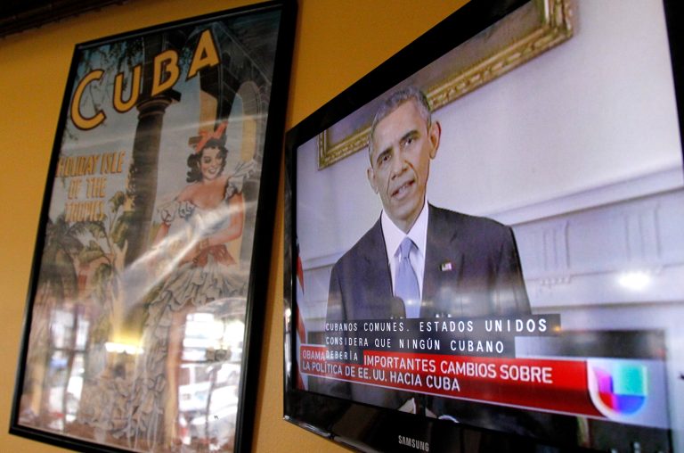 President Obama is shown on a television screen with Spanish captions as a Spanish language television network shows his speech live inside a Cuban coffee shop, Wednesday, Dec. 17, 2014, in Union City, N.J. (AP Photo/Julio Cortez)