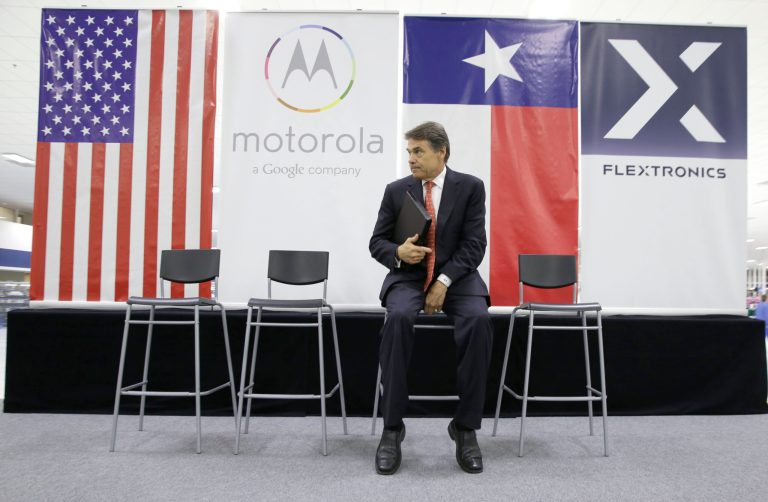 Texas Gov. Rick Perry sits on stage before an opening ceremony for a Motorola factory Tuesday, Sept. 10, in Fort Worth, Texas. The state has had success in attracting businesses even in a slumping economy. (AP Photo/LM Otero)