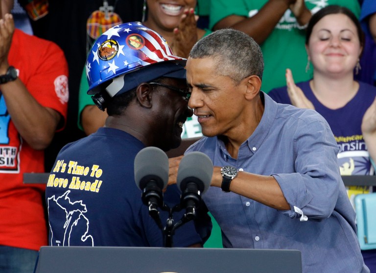 President Obama hugs Chris Harris, Vice President of United Steel Workers Local 2-209, after being introduced at Laborfest 2014 at Henry Maier Festival Park Monday, Sept. 1, 2014, in Milwaukee. Obama renewed his call for an increase in the minimum wage.  (AP Photo/Morry Gash)