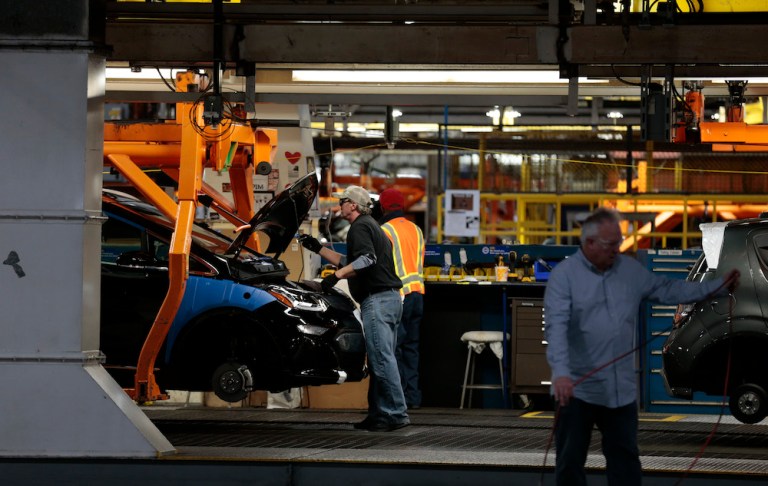 Workers assemble a 2019 Chevrolet Sonic vehicle and Chevrolet Bolt vehicle at the General Motors Co. Orion Assembly plant in Orion Township, Michigan, U.S., on Friday, March 22, 2019. General Motors Co.Â committed to investing $1.8 billion at plants in six states and to creating 700 new jobs, as the largest U.S. automaker looks to ward offÂ months of criticismÂ by PresidentÂ Donald Trump. 