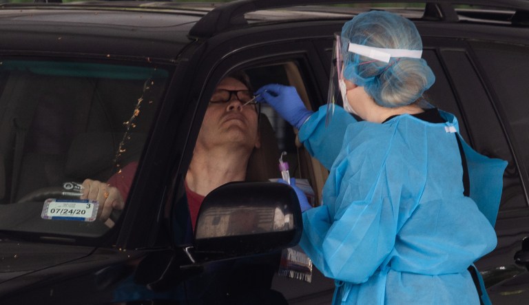 Healthcare workers prepare tests for COVID-19 at George Washington University Hospital in Washington, D.C.