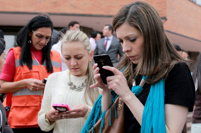 Women use their smart phones in the Colombian capital of Bogota.Â Colombian police have the technology to do things such as hack electronic devices unbeknownst to users.Â (AP Photo/Ricardo Mazalan)