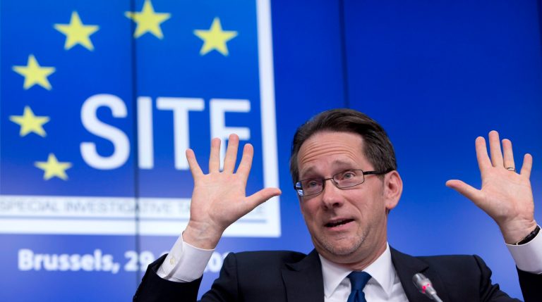American prosecutor for the EU Special Investigative Task Force Clint Williamson holds up ten fingers as he refers to the number of possible victims during a media conference at EU headquarters in Brussels on Tuesday, July 29, 2014. Williamson says there are 
