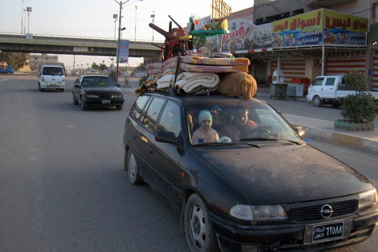 An Iraqi family with their belongings strapped to their car flee their home during clashes between the Iraqi army and al-Qaida fighters in Fallujah, 40 miles (65 kilometers) west of Baghdad, Iraq, Monday, Jan. 6, 2014. Clashes continued late Sunday and early morning Monday between al-Qaida and Iraqi troops on the main highway that links the capital, Baghdad, to neighboring Syria and Jordan. Al-Qaida fighters and allied tribes are still controlling the center of the city where they are deployed in streets and around government buildings. (AP Photo)