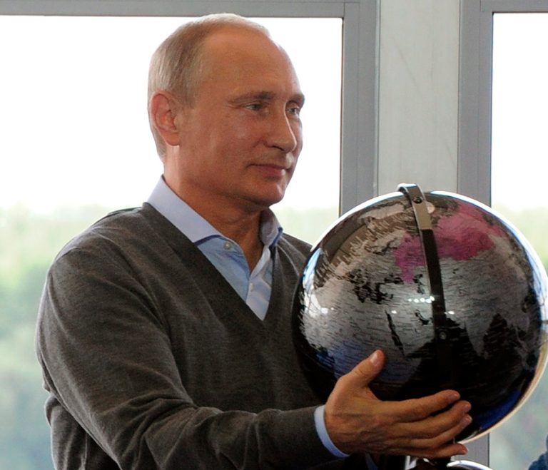 Russian President Vladimir Putin holds a terrestrial globe presented him as a gift at the Seliger youth camp near Lake Seliger, 280 miles northwest of Moscow, on Friday, Aug. 29, 2014.(AP Photo/RIA-Novosti, Mikhail Klimentyev, Presidential Press Service)
