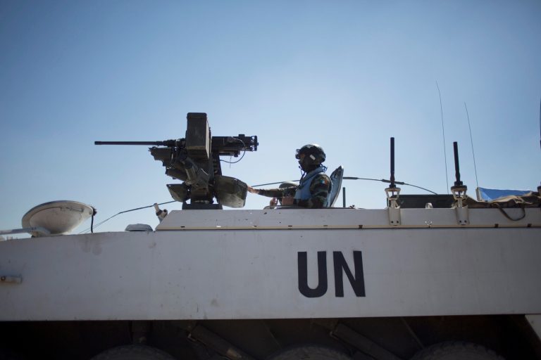 Armored vehicles from the U.N. peacekeepers of the United Nations Disengagement Observer Force, also known as UNDOF wait to cross from the Israeli controlled Golan Heights to Syria, Thursday, Aug. 28, 2014.  In southern Syria,  government warplanes targeted rebels near the country's frontier with Israel in the Golan Heights, a day after opposition fighters captured a crossing point on the disputed border. (AP Photo/Ariel Schalit)