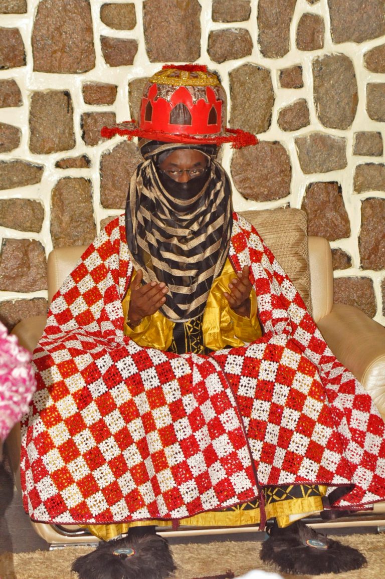 Traditional ruler Lamido Sanusi takes part in a prayer meeting Wednesday, June 11, 2014, at Kano State Government house in Kano, Nigeria. Lamido Sanusi was appointed on Sunday, June 8, 2014,  as the new emir of Kano, replacing Emir Ado Bayero who died at age 83.  (AP Photo/Sani Maikatanga)