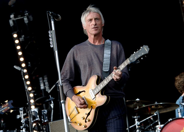 FILE - In this Saturday, June 29, 2013 file photo, British musician Paul Weller performs at the Hard Rock Calling Festival in the Queen Elizabeth Olympic Park, London. Paul Weller has won a privacy lawsuit against a newspaper that published paparazzi pictures of the singer's children. The former front man of The Jam and The Style Council sued Associated Newspapers over images of his daughter Dylan and twin sons John Paul and Bowie that appeared on its MailOnline website. Dylan was 16 and the twins 10 months old when the pictures, taken during a shopping trip in Santa Monica, were published in 2012. Judge James Dingemans ruled Wednesday that although publishing the pictures was legal in California, they 