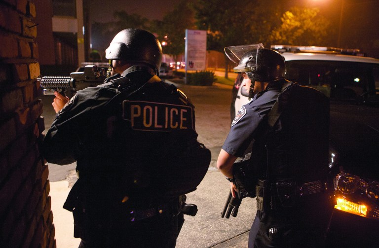 Police respond in Riverside, Calif., early Thursday morning, Feb. 7, 2013, after one officer was killed and another critically wounded in a shoot out with a murder suspect. Police were searching for a former Los Angeles police officer sought for two weekend killings , and who threatened to kill police. There were two separate overnight shootings about 60 miles east of Los Angeles in Riverside County that investigators believe involved former LA police officer Christopher Dorner, who's also the main suspect in the weekend killing of a couple whose bodies were found in Irvine. He was fired in 2008 for making false statements. (AP Photo/Kevin Warn)