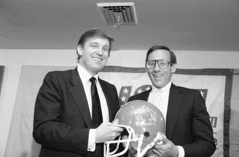 New York real estate magnates Steve Ross, right, and Donald Trump, left, announce agreement, Thursday, August 1, 1985 in New York, to merge the Houston Gamblers and the New Jersey Generals United States Football League teams. (AP Photo/Marty Lederhandler)