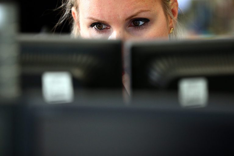 An employee views trading screens at the offices of Panmure Gordon and Co on October 20, 2014 in London, England. (Photo by Carl Court/Getty Images)