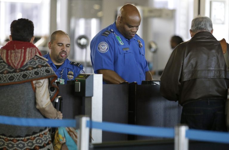 Transportation Security Administration agents check travelers identifications at a security check point area in Terminal 3 at O'Hare International Airport in Chicago. (AP Photo/Nam Y. Huh, File)