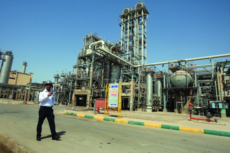 FILE - In this Wednesday, Sept. 28, 2011 file photo, an Iranian security guard stands at the Maroun Petrochemical plant at the Imam Khomeini port, southwestern Iran. Iranian officials unleashed sharper attacks against tightening Western sanctions Tuesday, equating the financial pressure to ``warfare'' and vowing to counter by retooling the country's oil-dependent economy. (AP Photo/Vahid Salemi, File)
