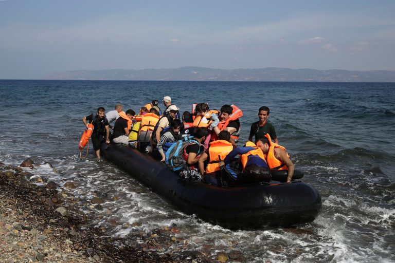 Syrian and Iraqi refugees arrive at the coast on a dinghy after crossing from Turkey, at the island of Lesbos, Greece, Tuesday, Sept. 8, 2015. (AP Photo/Petros Giannakouris)