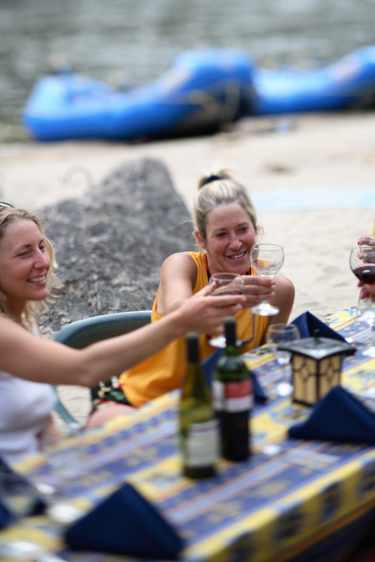This undated photo released by Far and Away Adventures shows campers drinking wine on a 