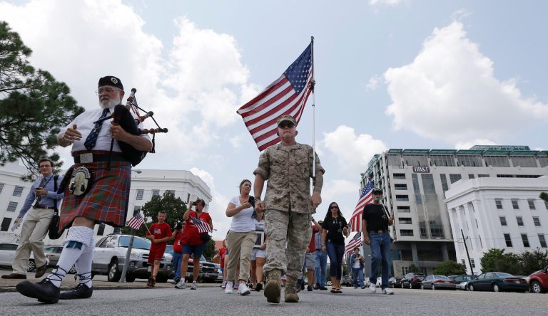 Marine Corps veteran Mac McQuown walks up Dexter Avenue to the historic Alabama Capitol in Montgomery, Ala. (AP/Dave Martin)