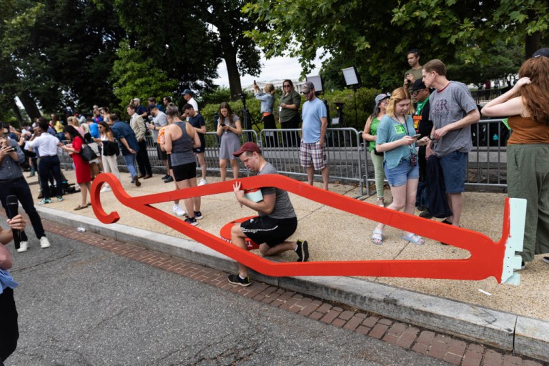 Pro-abortion rights protesters use signs and other items in opposition to the overturning of Roe v. Wade on Friday in Washington.