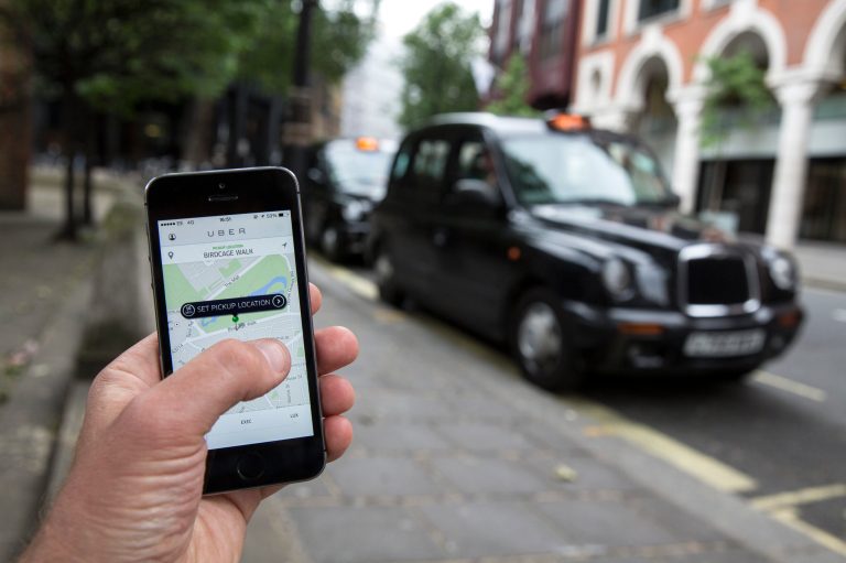 A smartphone displays the 'Uber' mobile application, which allows users to hail private-hire cars from any location. (Oli Scarff/Getty Images)