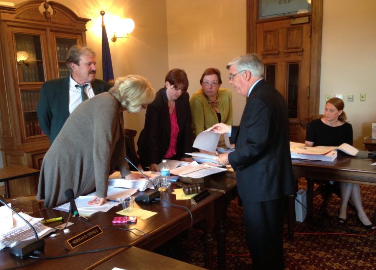 Michigan Elections Director Chris Thomas shows members of the Board of State Canvassers petition signatures his staff checked before determining that a group proposing to raise the minimum wage fell short of the signatures needed to put its proposal before the Legislature and possibly a statewide vote, at the state Capitol on Thursday, July 24, 2014, in Lansing, Mich. The board voted 3-1 not to certify the measure. (AP Photo)