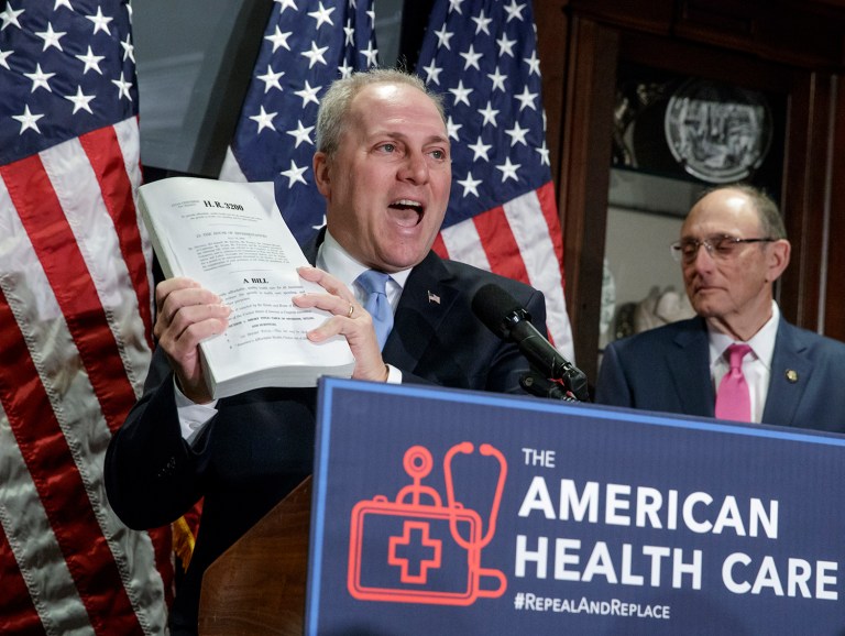 House Majority Whip Steve Scalise of La., left, joined by Rep. Phil Roe, R-Tenn., holds up a copy of the original Affordable Care Act bill during a news conference on Capitol Hill in Washington, Wednesday, March 8, 2017, as the GOP leadership talks about its work on the long-awaited Republican plan to repeal and replace 