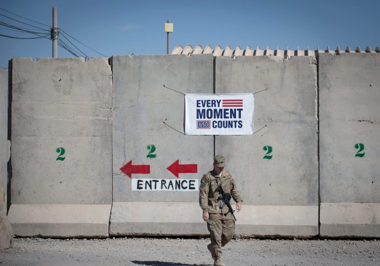 A U.S. soldier walks out of a building protected by a blast wall at Kandahar airfield on Nov. 10, 2014 in Kandahar, Afghanistan. (Photo by Matt Cardy/Getty images)