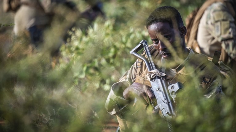 A Somali Soldier assigned to the 3rd DANAB, a highly trained Somali National Army infantry commando force, maintains a watchful eye during a short security halt a on patrol near the town of Wanla Weyn, Somalia on July 22, 2019.