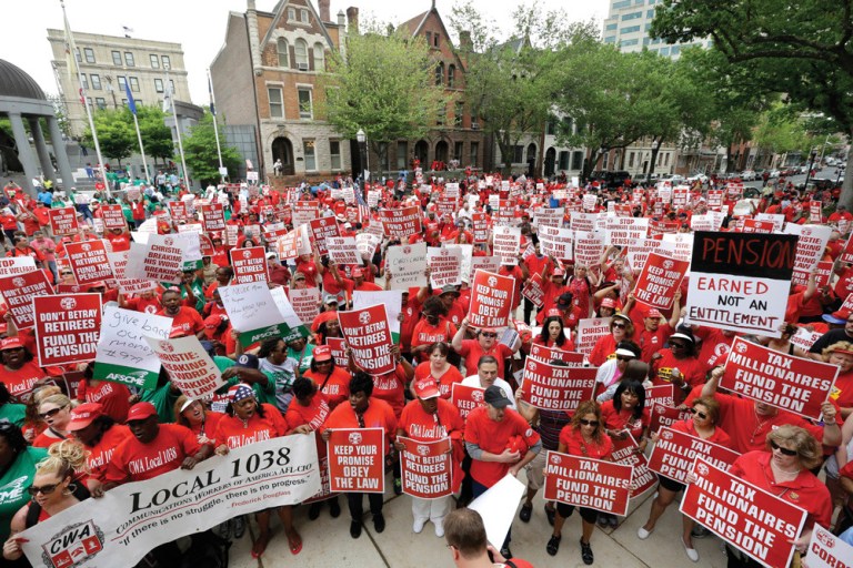 A large crowd of mostly public employee union members fill the plaza and street. (AP Photo/Mel Evans)