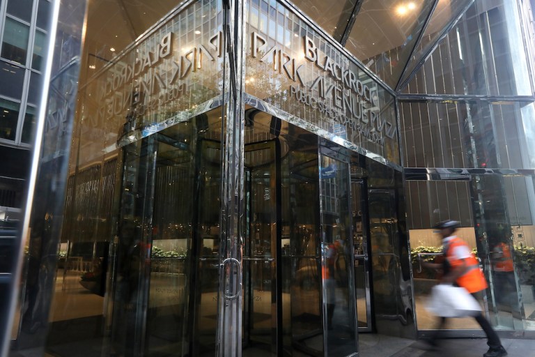 A pedestrian enters BlackRock Park Avenue Plaza in New York. 