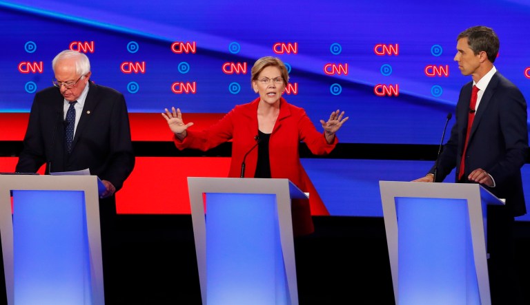 Sen. Elizabeth Warren, D-Mass., speaks as she participates in the first of two Democratic presidential primary debates hosted by CNN Tuesday, July 30, 2019, in the Fox Theatre in Detroit. Sen. Bernie Sanders, I-Vt., left, and former Texas Rep. Beto O'Rourke listen.