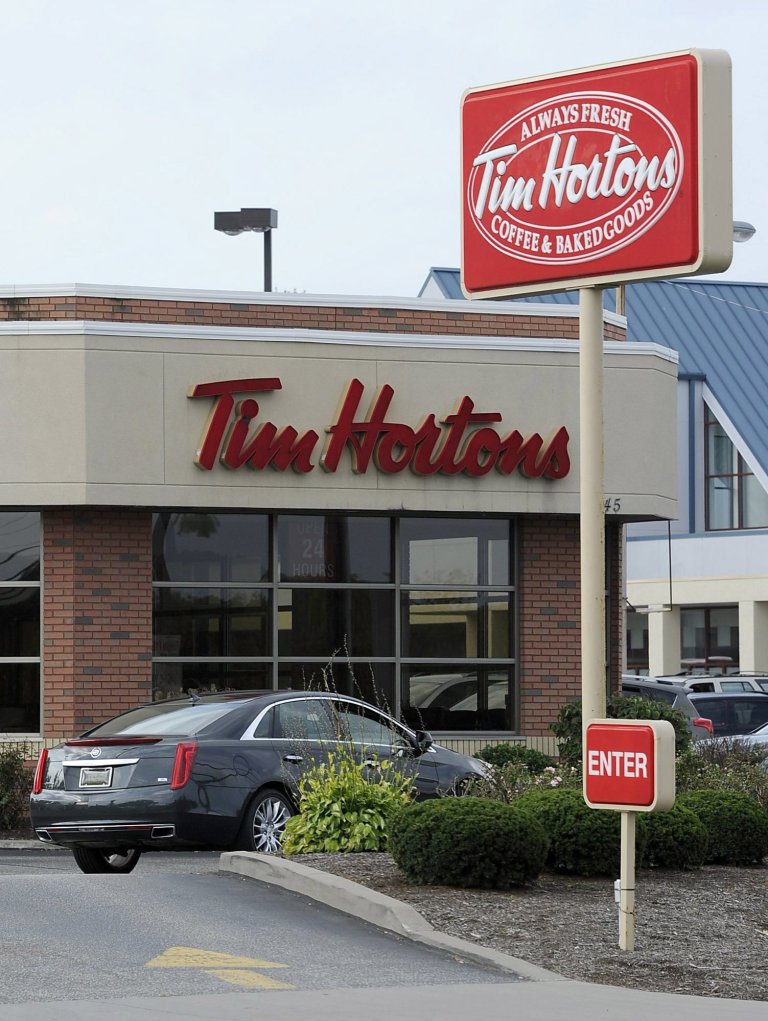 A Tim Hortons restaurant is seen on W. 26th Street in Millcreek Township, Pa., on Tuesday, Aug. 26, 2014. Burger King struck an $11 billion deal to buy Tim Hortons that would create the world's third largest fast-food company and could make the Canadian coffee-and-doughnut chain more of a household name around the world. (AP Photo/Erie Times-News, Christopher Millette)