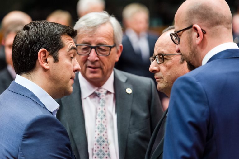 Greek Prime Minister Alexis Tsipras, left, speaks with, from left, European Commission President Jean-Claude Juncker, French President Francois Hollande and Belgian Prime Minister Charles Michel during a meeting of eurozone heads of state at the EU Council building in Brussels on Sunday, July 12, 2015. (AP Photo/Geert Vanden Wijngaert)