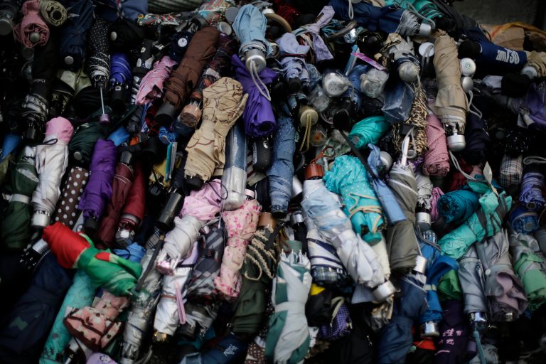 Umbrellas are stacked at the protest site for pro-democracy activists' use if they need to shield themselves from pepper spray, Monday, Sept. 29, 2014 in Hong Kong. Pro-democracy protesters expanded their rallies throughout Hong Kong on Monday, defying calls to disperse in a major pushback against Beijing's decision to limit democratic reforms in the Asian financial hub. (AP Photo/Wong Maye-E)