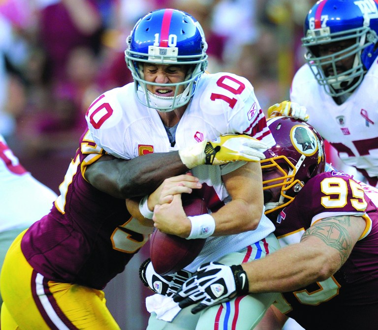 Susan Walsh/AP
The Redskins got pressure on Giants quarterback Eli Manning a year ago, sacking him seven times total in their two victories over the Super Bowl champions.