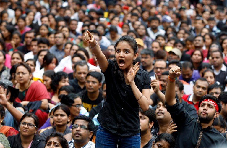 An angry protester points her finger towards the Bangalore police chief during a protest against alleged police inaction after a six-year-old was raped at a school, in Bangalore, India, Saturday, July 19, 2014. More than 4,000 parents and relatives of children who attend the school shouted slogans against the school's administration Saturday and demanded that police arrest those involved in the July 2 incident, which was reported only this past week. (AP Photo/Aijaz Rahi)