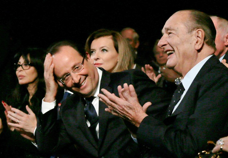 Former French President Jacques Chirac, right, applauds while French President Francois Hollande smiles after the award ceremony for the 