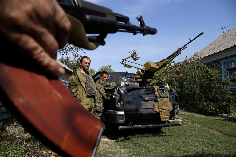 Pro-Russian rebels stand next to their car with a heavy machine gun in Donetsk, eastern Ukraine, Sunday, Sept. 7, 2014. (AP Photo/Sergei Grits)