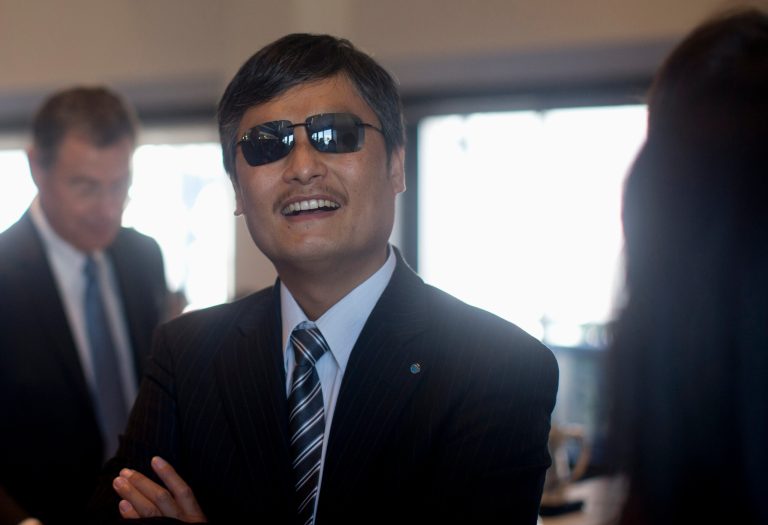   Chinese activist Chen Guangcheng talks with colleagues before speaking at the National Press Club in Washington, Wednesday, Oct. 2, 2013. Guangcheng says he has new affiliations with Lantos Foundation for Human Rights and Justice, the Catholic University of America and the William E. and Carol G. Simon Center on Religion and Constitution of the Witherspoon Institute after leaving New York University under disputed circumstances. (AP Photo/Carolyn Kaster)  
