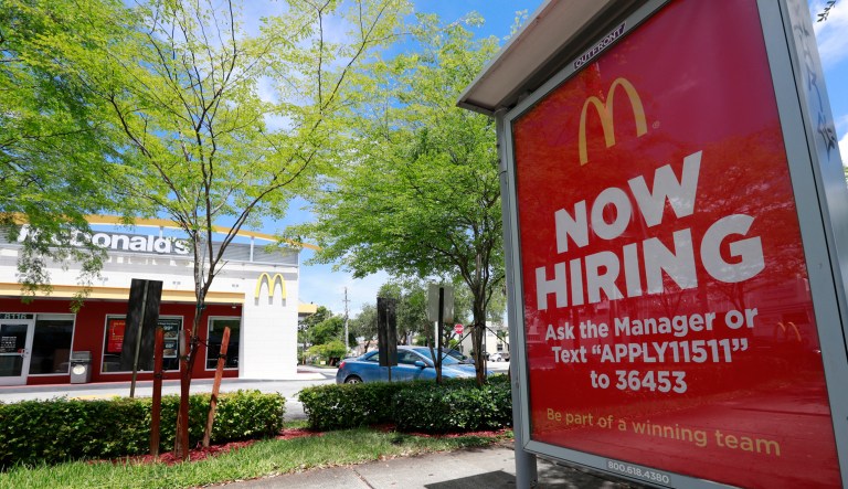 In this Monday, July 1, 2019 photo, a help wanted sign appears on a bus stop in front of a McDonald's restaurant in Miami. On Tuesday, July 9, the Labor Department reports on job openings and labor turnover for April.