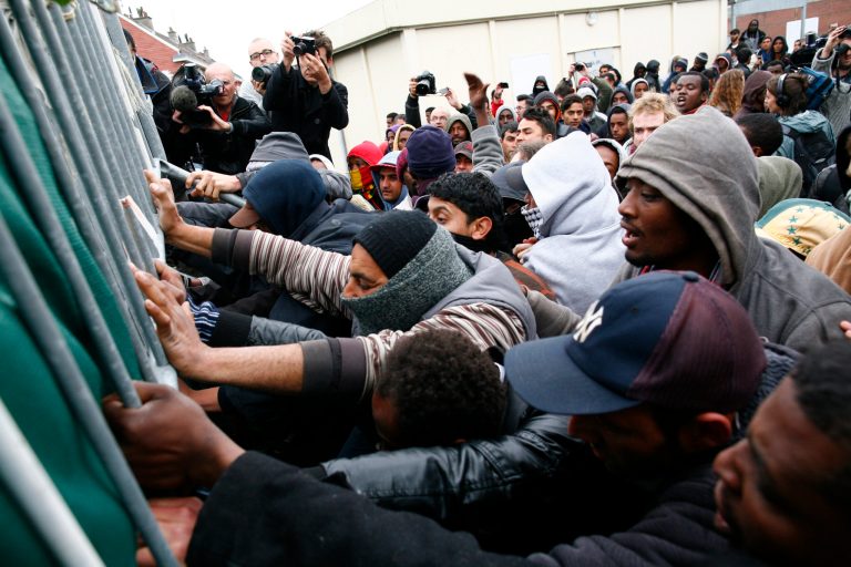 Migrants and activists scuffle with police officers after French authorities started to clear out makeshift camps in the English Channel port city of Calais, northern France, housing hundreds of illegal migrants from Syria, Afghanistan and Africa, Wednesday, May 28, 2014. French media reports say that Calais authorities wanted the camps cleared out because of a scabies epidemic. (AP Photo/Thibault Vandermersch)