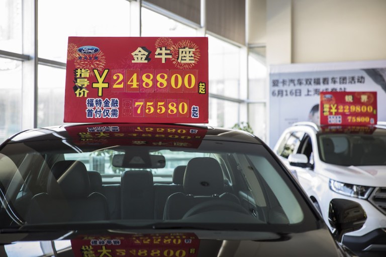 A price sign atop a Ford Taurus in Shanghai, China. The brewing U.S.-China trade war is edging closer to the point of no return, according to analysts from Swiss lender UBS.